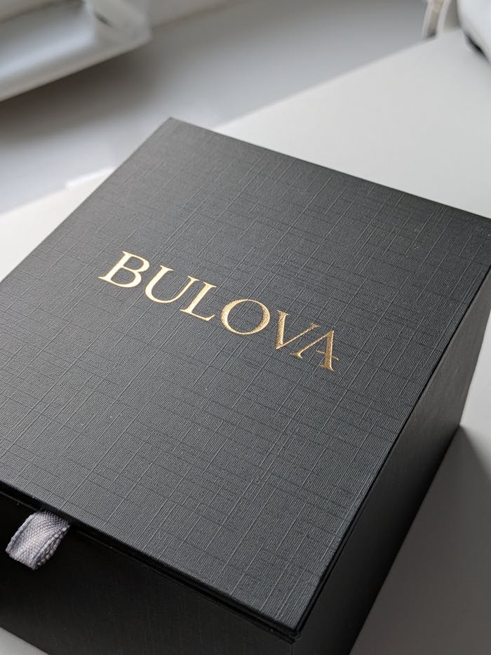 Sophisticated Bulova gift box with textured design, captured in natural daylight.